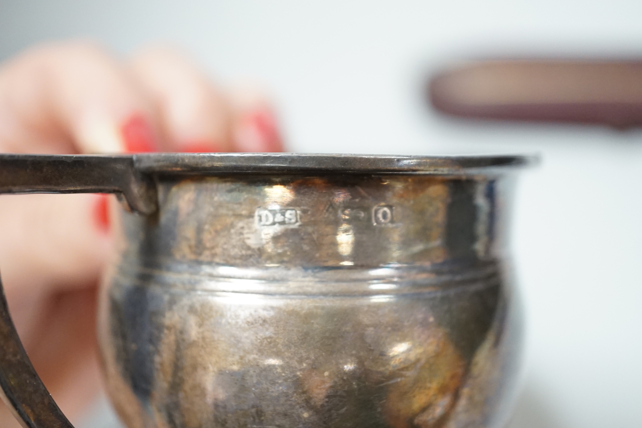 A George V silver christening mug, a cased Victorian silver christening spoon by George Adams and a plated christening mug.